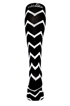 Black and white compression sock with zigzag pattern. Back view.