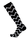 Black and white compression sock with zigzag pattern. Side view.